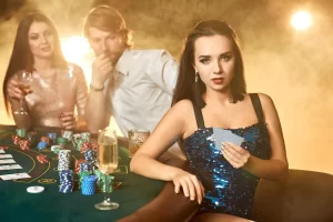 scatterna website image 295 showing group elegant people playing poker gambling house focus emotional brunette blue shiny dress passion cards chips alcohol dice gambling casino it is entertainment dange 639032 1709 secondary placement 2